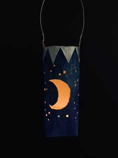 a paper bag with an orange moon on it