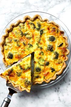 a quiche with broccoli and cheese cut into slices