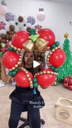 a woman sitting on a chair with balloons in the shape of hearts and bells around her neck