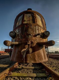 an old rusty train car sitting on the tracks