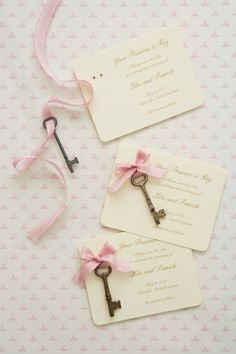 the keys are tied with pink ribbon and placed on top of each other for an elegant touch