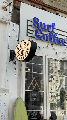 the surf coffee sign is on the side of the building