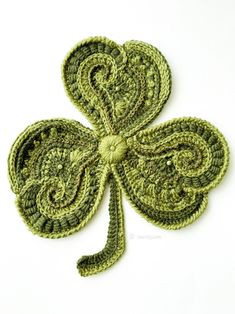 a crocheted shamrock is shown on a white surface