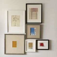 four different framed pictures hanging on the wall