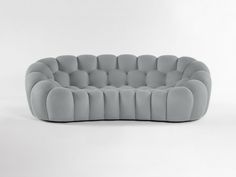 a gray couch sitting on top of a white floor