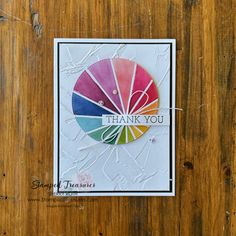 a card with the words thank you on it, and a colorful circle that says thank you