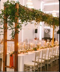 an outdoor wedding reception with greenery and candles