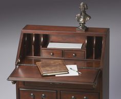 a wooden desk with drawers and a book