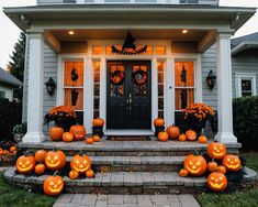 pumpkins on the front steps of a house decorated for halloween