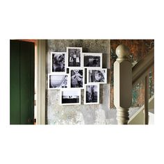 a bunch of pictures hanging on the wall next to a green door and some stairs