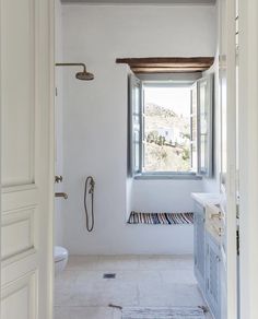 an open door leading to a bathroom with a window