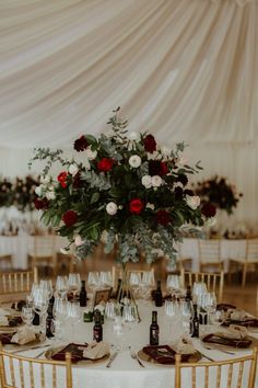 a table set up with wine glasses and flowers