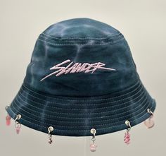 Slander Bucket Hat is the perfect addition to any festival or rave outfit. Made to be both stylish and functional, this bucket hat is a must-have clothes accessory for any fashion-forward individual.  Crafted with high-quality materials, this bucket hat guarantees long-lasting use while keeping your head cool and comfortable. Its sleek design allows you to pair it with a variety of outfits, making it a versatile piece in your fashion accessories collection. Whether you're out in the sun or dancing all night long, Slander Bucket Hat has got you covered - literally! Don't miss out on this trendy rave accessory! Affordable Cap For Music Festival, Cheap Festival Bucket Hat, Festival Bucket Hat, Bucket Hat Outfit 90s, Cool Bucket Hats, Rave Hats, Festival Hats, Bucket Hat Outfit, Embroidered Bucket Hat