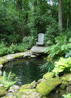 a chair sitting on top of a wooden platform next to a small pond filled with water