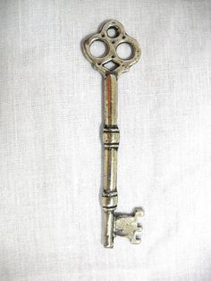 an old metal key on a white cloth