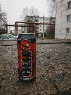 a can of beer sitting on the ground