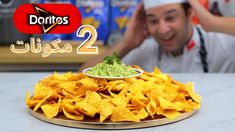 a man sitting in front of a plate filled with chips and guacamole