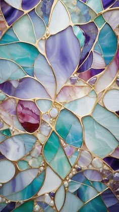 a close up view of a colorful glass mosaic wallpaper with gold and blue colors