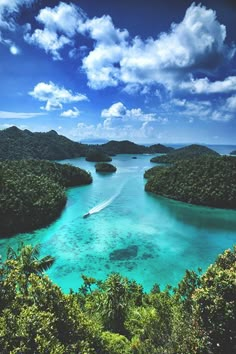 an aerial view of the water and land in the tropical island with trees on both sides