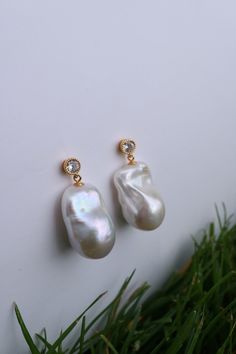 Baroque Pearl Dangle Earrings are made from high-quality sterling silver and coated with 14K gold plating. Our baroque pearl drop earrings are not only perfect for weddings and brides, but they also effortlessly elevate any outfit, from casual jeans and a cozy cardigan to elegant evening attire.  Whether you're a bride searching for the ideal wedding accessory or a fashion-forward individual looking to enhance your everyday style, our Baroque Pearl Earrings with cubic zirconia studs are the epit Pearl Drop Bridal Earrings, Anniversary Drop Earrings With Pearl Charm, White Gold Drop Earrings With Pearl Charm, Teardrop Pearl Charm Earrings For Anniversary, Anniversary Drop Pearl Earring, Fine Jewelry Dangle Earrings With Pearl Charm, Fine Jewelry Teardrop Earrings With Pearl Charm, Pear-shaped Single Earring For Anniversary, Anniversary Drop Pearl Earrings With Plating