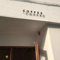 there is a coffee shop sign above the door