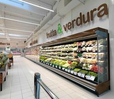 a produce section in a grocery store filled with fruits and vegetables