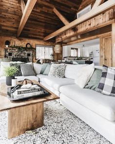 a living room filled with furniture and wooden walls