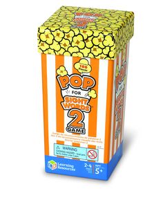 a box of popcorn sitting on top of a white table next to an orange and white striped box