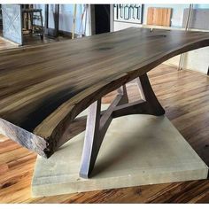 a large wooden table sitting on top of a hard wood floored flooring area