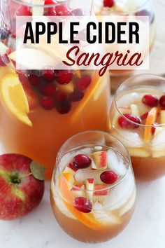 an apple cider sangria is garnished with cranberries and orange slices