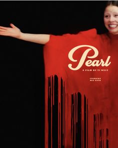 a woman in a red shirt is holding her arms out with the words pearl on it