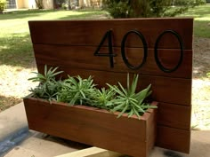 a wooden planter with plants growing in it