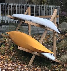 two surfboards are propped up on a wooden stand