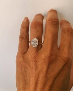 a person's hand with a diamond ring on it