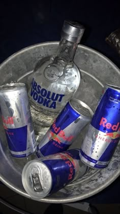 several cans and cans of vodka in a metal bowl