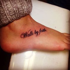 a person's foot with the words walk by faith written on it, in black ink