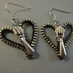 two pairs of heart shaped scissors hanging from earwires on a gray surface with silver hooks