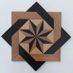 a wooden wall hanging with an abstract design on it