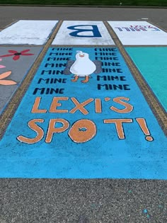 an advertisement painted on the ground in front of a parking lot that says, let's spot