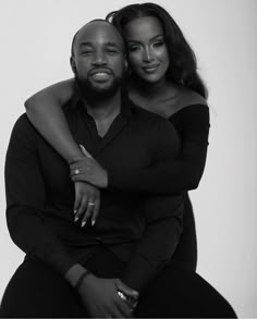 a black and white photo of two people hugging each other with their arms around one another