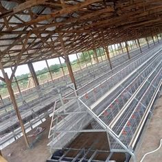 the inside of a building with many cages in it