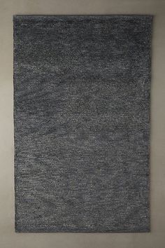 an area rug is shown on the floor in front of a white wall and grey walls