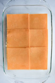 four squares of cheese in a glass dish