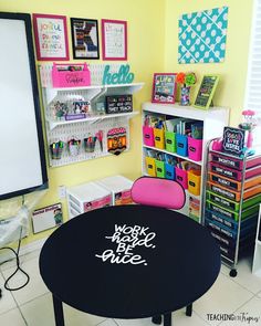 a black table sitting in the middle of a room filled with lots of crafting supplies