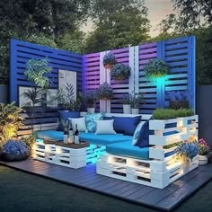 a blue couch sitting on top of a wooden deck next to plants and trees in the background