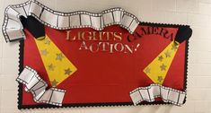 there is a red and yellow sign that says lights camera action with stars on it