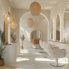 the interior of a hair salon with chairs, mirrors and potted plants on the wall