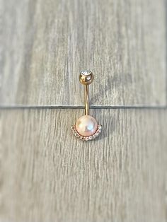 This cute dainty belly button ring is made with surgical steel, and is a great addition to your belly button jewelry collection!  Drop jaws with this body jewelry. Available in gold, rose gold and silver. The rose gold has a pink-ish pearl, and the gold and silver have a white pearl. Details & Size: ♥ 316L Surgical Steel & Faux Pearl ♥ Available in silver, rose gold and gold ♥ 10mm, 14G Bar ♥ Externally Threaded ♥ Every purchase comes with an Elara gift box For sanitary purposes, piercing items Gold Belly Button Jewelry, Rose Gold Belly Button Piercing, Elegant Gold Belly Rings, Gold Pearl Belly Button Piercing, Cheap Elegant Gold Belly Rings, Pink And Gold Belly Button Piercing