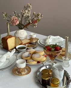 a table topped with plates and cups filled with food