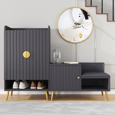 a grey cabinet with gold handles and shoes on it in front of a stair case